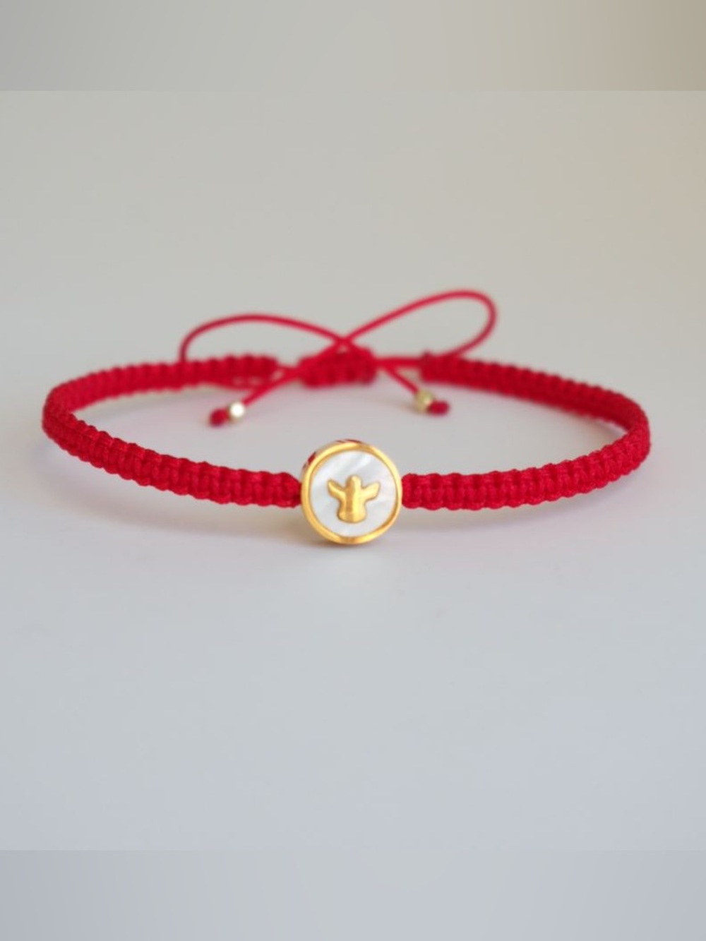 Adjustable Red Woven Bracelet with Gold Mother-of-Pearl Angel Bead